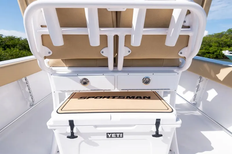 Slide: The Image of The image shows the rear area of a Sportsman Open 232 Center Console boat with a Yeti cooler. - 12