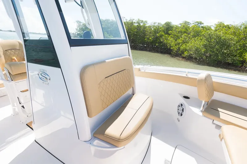 Slide: The Image of The 2025 Sportsman Open 232 Center Console boat features a sleek, cushioned seat and modern console. - 6