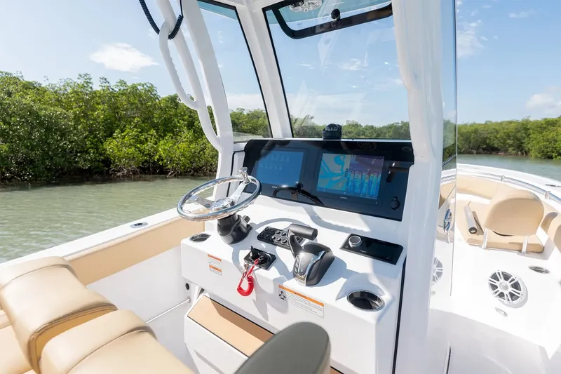 Slide: The Image of The image shows the cockpit of a 2025 Sportsman Open 232 Center Console boat with modern electronics. - 5