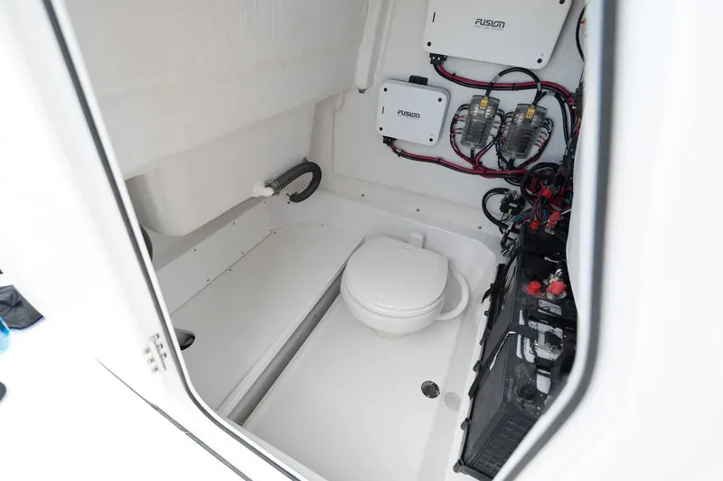 Slide: The Image of The image shows the interior of a boat with a toilet and electrical connections. - 7