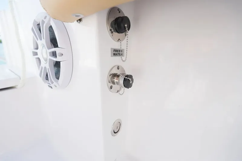 Slide: The Image of Close-up of a speaker and fresh water connection on a Sportsman Open 232 Center Console boat. - 14