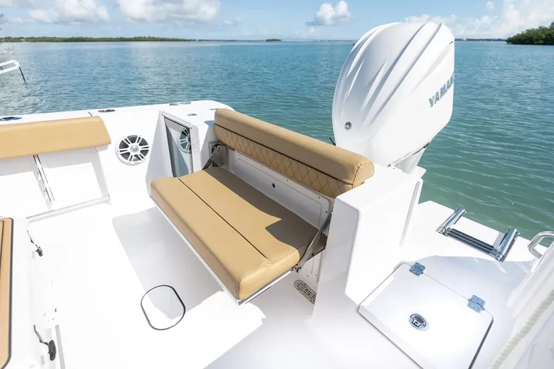 Slide: The Image of The image shows the stern of a Sportsman Open 232 Center Console boat with beige seating and Yamaha engine. - 16