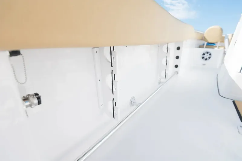Slide: The Image of The image shows the deck of a 2025 Sportsman Open 232 Center Console boat with white surfaces. - 13