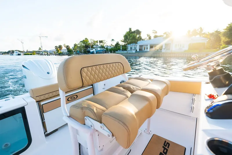 Slide: The Image of The image shows the cockpit of a 2025 Sportsman Open 232 Center Console boat with beige seating. - 11