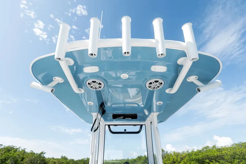 Slide: The Image of The image shows the T-top of a Sportsman Open 232 Center Console boat with multiple rod holders. - 10