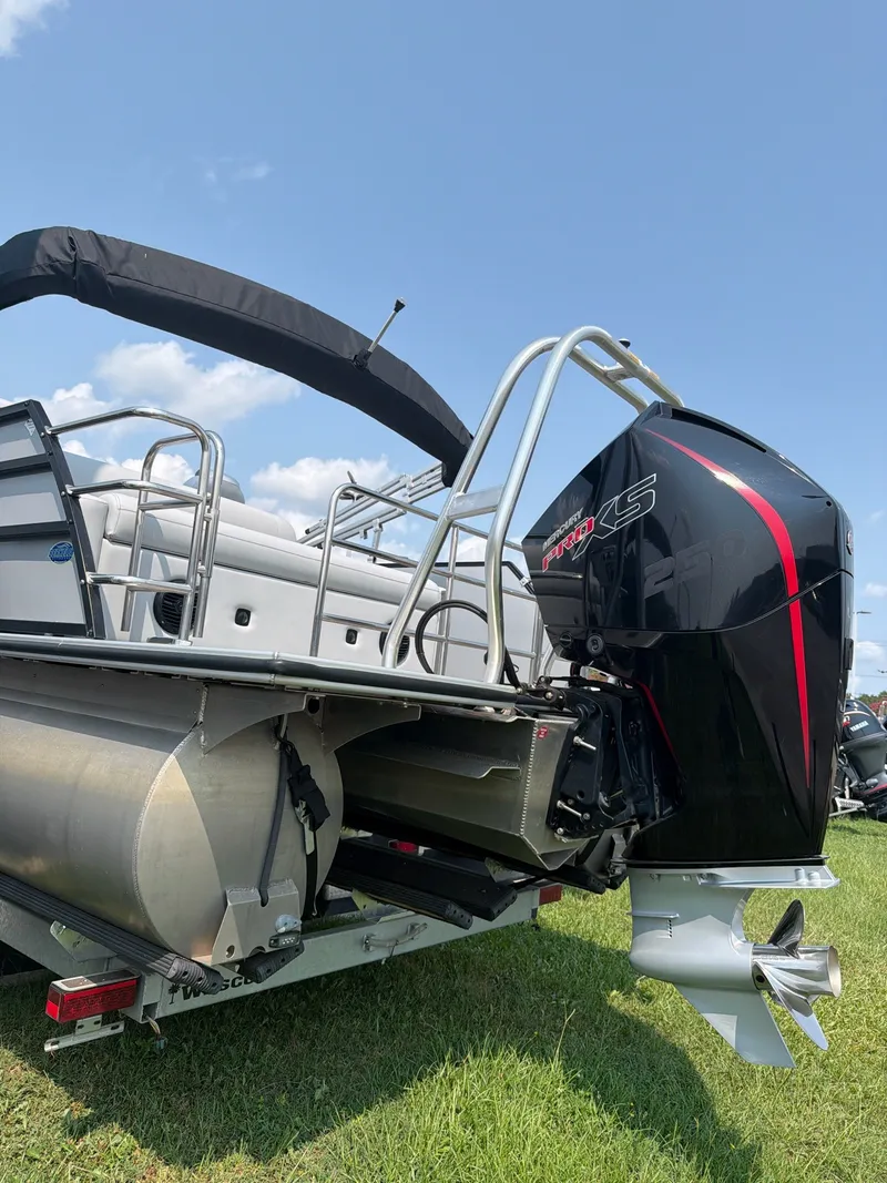 Slide: The Image of A 2022 Bentley Pontoons ELITE 253 TRITOON with a powerful outboard motor on a trailer. - 6