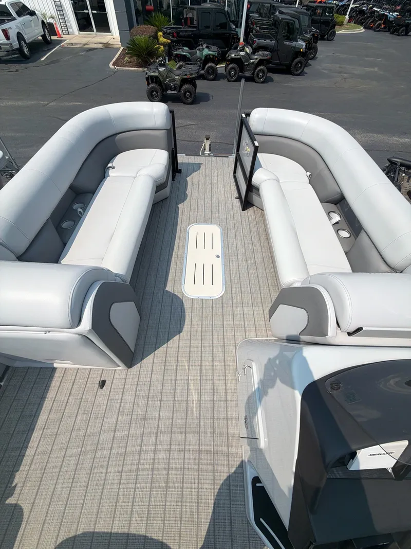 Slide: The Image of The image shows the deck of a 2022 Bentley Pontoons ELITE 253 TRITOON with gray upholstered seating. - 4