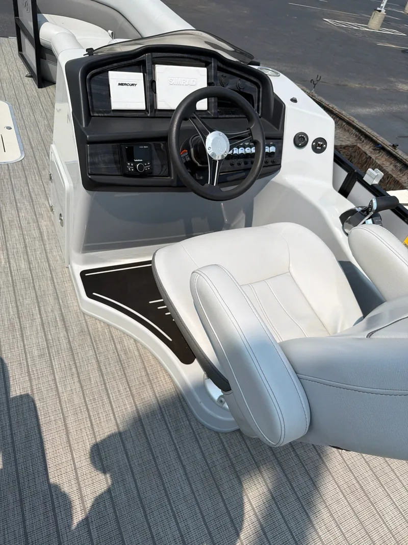 Slide: The Image of The image shows the cockpit of a Bentley Pontoons ELITE 253 TRITOON with a sleek steering wheel and comfortable seating. - 3