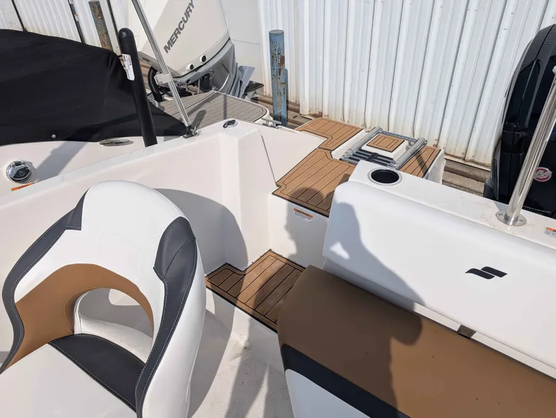 Slide: The Image of The image shows the cockpit of a 2025 Starcraft SVX 171 OB with modern seating and teak flooring. - 14