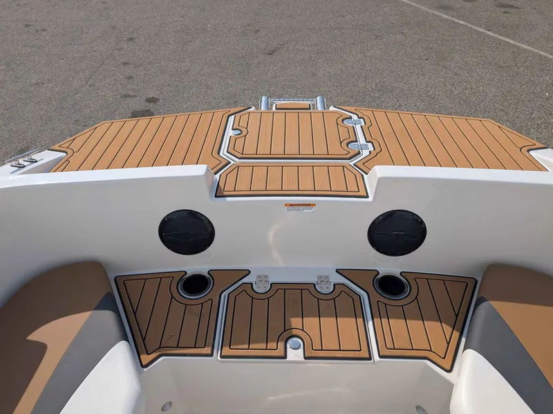 Slide: The Image of The image shows the deck of a Starcraft SVX 171 OB boat with wood-like finish and speakers. - 5