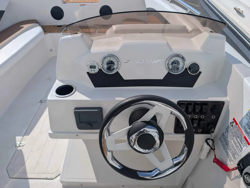 Slide: The Image of The image shows the helm of a 2025 Starcraft SVX 171 OB boat with modern instruments. - 13