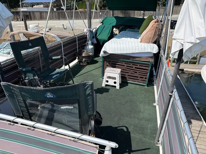 Slide: The Image of The image shows the deck of a 1977 Cruise-A-Home 40 with lounge chairs and a bed. - 5