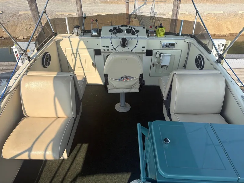 Slide: The Image of The image shows the cockpit of a 1977 Cruise-A-Home Corsair 40. It features beige seats and a blue table. - 12
