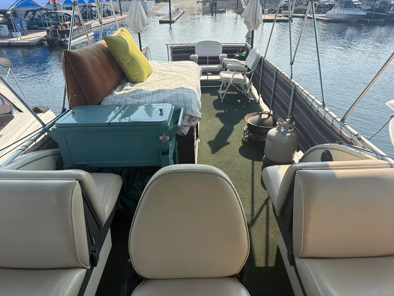 Slide: The Image of The image shows the deck of a 1977 Cruise-A-Home Corsair 40 with seating and a table. - 14