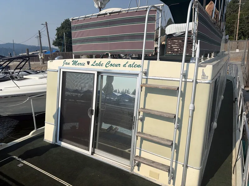 Slide: The Image of 1977 Cruise-A-Home Corsair 40 with sun deck and ladder, docked at a marina. - 6