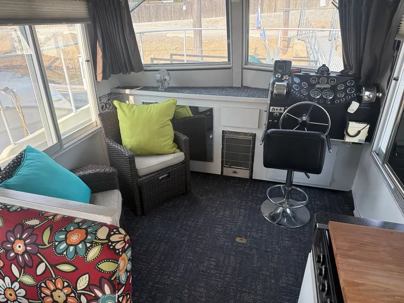 Slide: The Image of Interior of a 1977 Cruise-A-Home Corsair 40 with cozy seating areas and a helm station. - 25