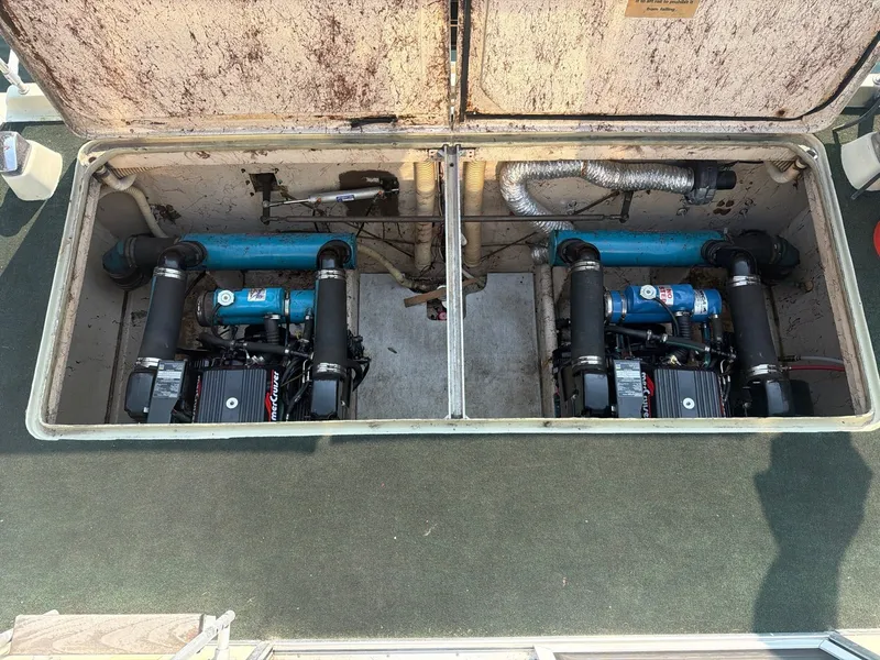 Slide: The Image of The engine compartment of a 1977 Cruise-A-Home Corsair 40 with two engines and blue pipes. - 28