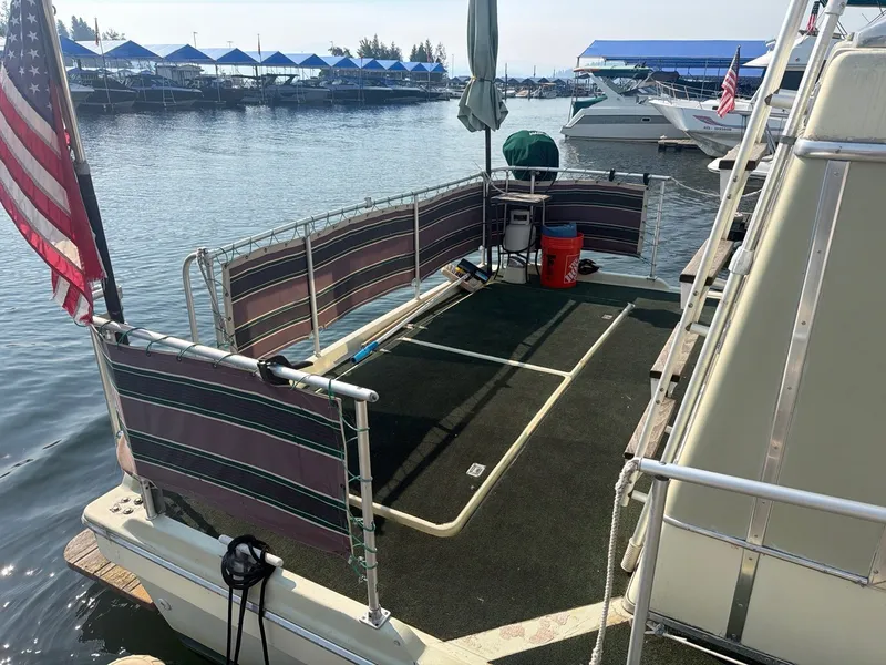 Slide: The Image of The image shows the stern of a 1977 Cruise-A-Home Corsair 40 with a spacious deck and railing. - 5