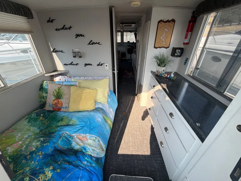 Slide: The Image of Interior of a 1977 Cruise-A-Home Corsair 40 with a cozy bed and decorative pillows. - 16