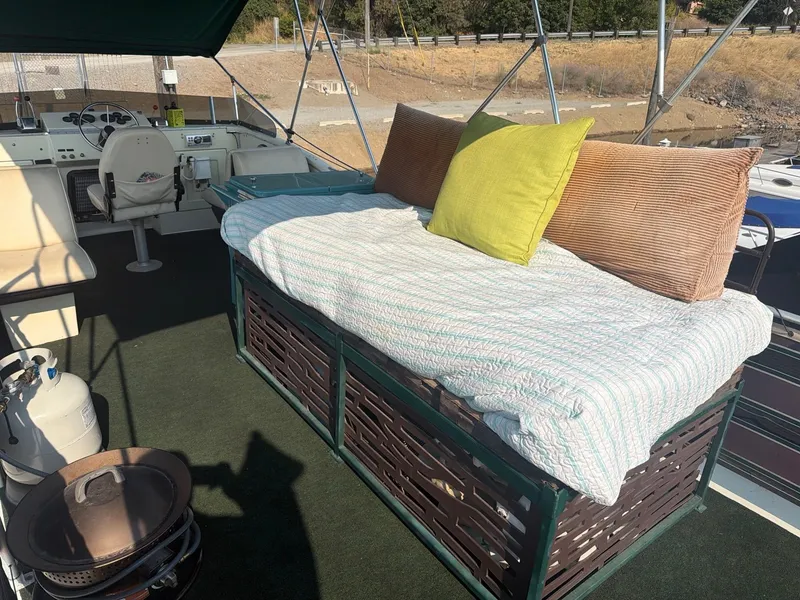 Slide: The Image of The image shows the deck of a 1977 Cruise-A-Home Corsair 40 with a cozy lounging area. - 11