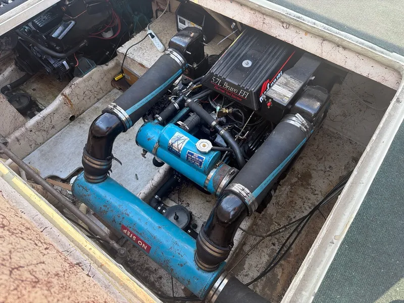 Slide: The Image of The engine compartment of a 1977 Cruise-A-Home Corsair 40 with visible engine and piping. - 29