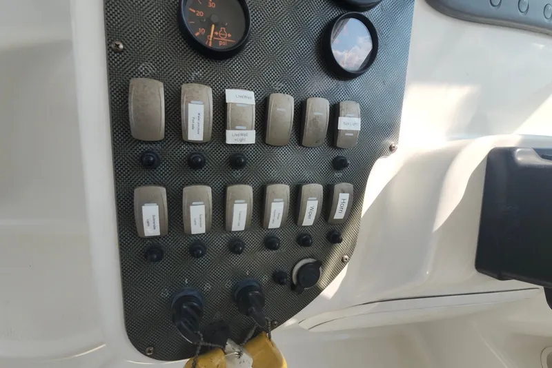 Slide: The Image of Control panel of a 2005 Seaswirl Striper 2901 Walkaround O/B boat with labeled switches. - 27