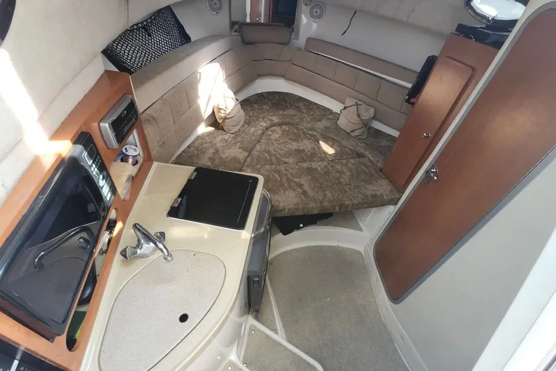 Slide: The Image of Interior of 2005 Seaswirl Striper 2901 Walkaround O/B with cozy seating and kitchenette. - 21