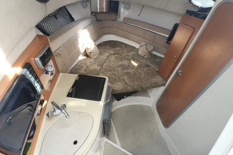 Slide: The Image of 2005 Seaswirl Striper 2901 Walkaround O/B cabin interior with kitchenette and seating area. - 18