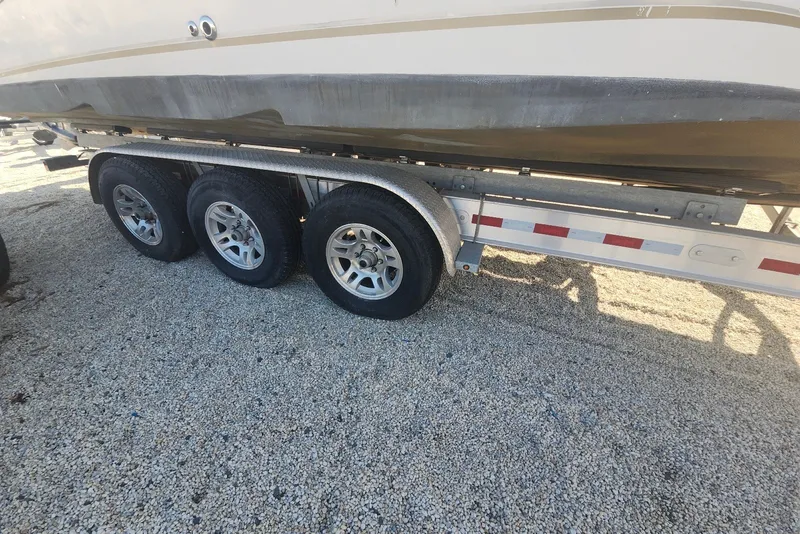 Slide: The Image of 2005 Seaswirl Striper 2901 Walkaround O/B on a triple-axle trailer. - 36