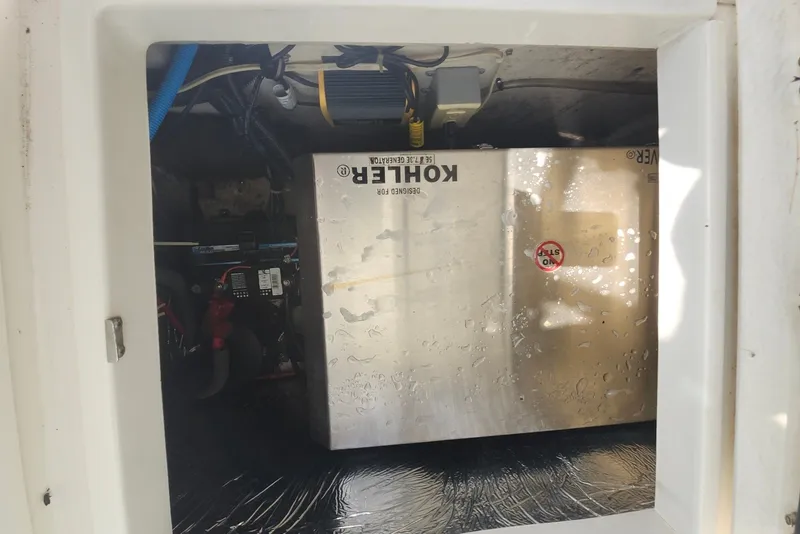 Slide: The Image of Engine compartment of a 2005 Seaswirl Striper 2901 Walkaround O/B with Kohler generator. - 32