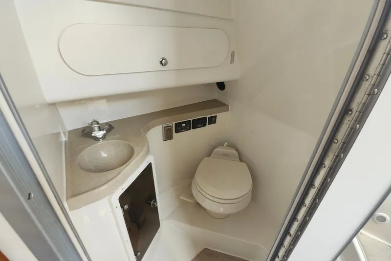 Slide: The Image of 2005 Seaswirl Striper 2901 Walkaround O/B boat bathroom with sink and toilet. - 20