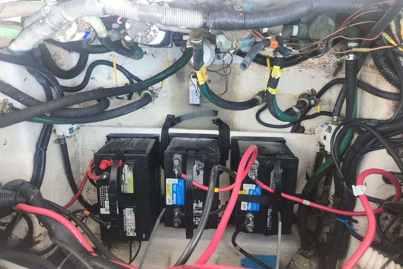 Slide: The Image of Battery compartment of a 2005 Seaswirl Striper 2901 Walkaround O/B with wiring and connections. - 35