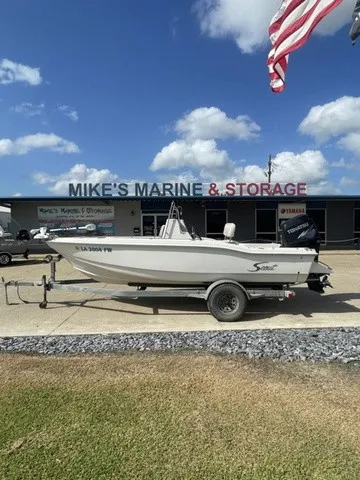 Slide: The Image of 1997 Scout 185 Sportfish in front of a marine store. - 17