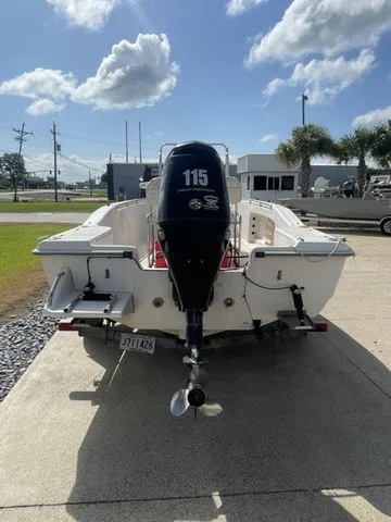 Slide: The Image of A 1997 Scout 185 Sportfish boat with a 115 HP outboard motor, on a trailer. - 18