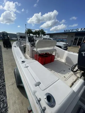 Slide: The Image of A 1997 Scout 185 Sportfish on a trailer. The sky is partly cloudy. - 23