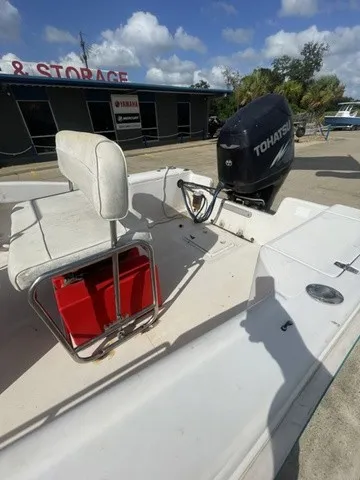 Slide: The Image of A 1997 Scout 185 Sportfish with a Tohatsu outboard motor. It is parked on a lot. - 25