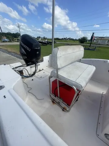 Slide: The Image of A 1997 Scout 185 Sportfish with a Tohatsu outboard motor and a white bench seat. - 22