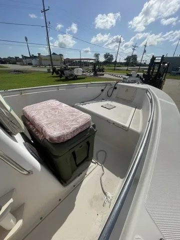 Slide: The Image of A 1997 Scout 185 Sportfish with an open bow view, seating, and helm console. - 31