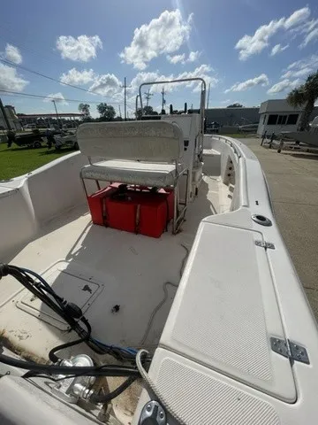 Slide: The Image of A 1997 Scout 185 Sportfish boat with an open console and red seat cushion. - 29