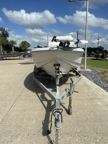 Slide: The Image of A 1997 Scout 185 Sportfish boat is on a trailer in a paved area. - 20