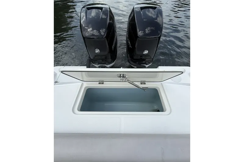 Slide: The Image of Boston Whaler 330 Outrage 2016 with dual Mercury outboard engines and open storage compartment. - 29