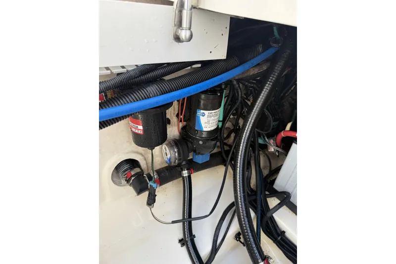 Slide: The Image of Boston Whaler 330 Outrage 2016 boat wiring and pump system close-up. - 38
