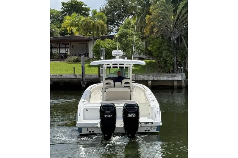 Slide: The Image of 2016 Boston Whaler 330 Outrage boat with dual 350 engines on a calm waterway. - 6