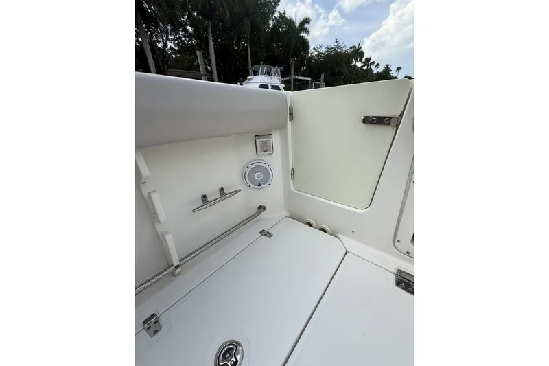 Slide: The Image of Interior view of a 2016 Boston Whaler 330 Outrage boat, featuring storage and speaker. - 21