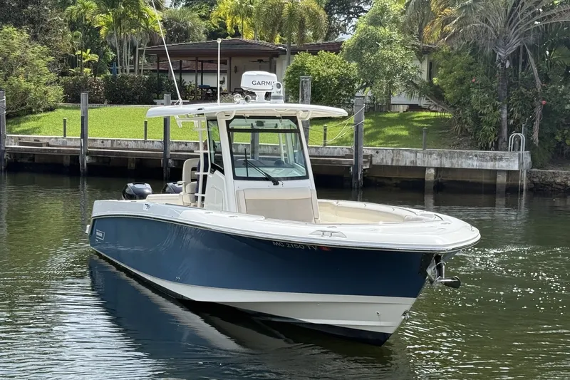 Slide: The Image of 2016 Boston Whaler 330 Outrage boat docked on a serene waterfront. - 4