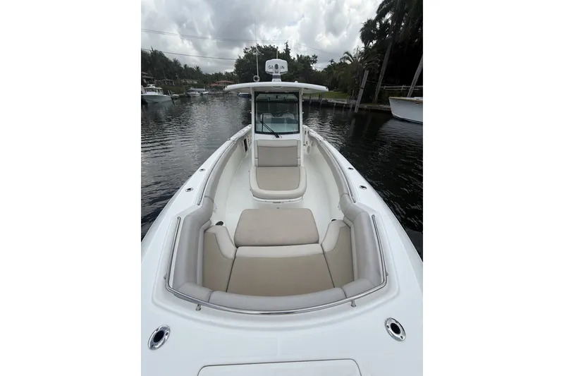 Slide: The Image of 2016 Boston Whaler 330 Outrage boat with spacious seating on a calm waterway. - 15