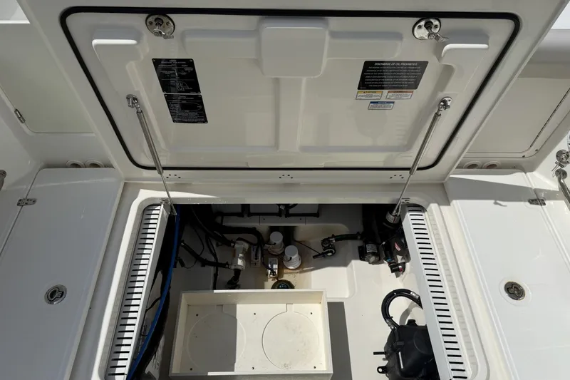 Slide: The Image of Open hatch of a 2016 Boston Whaler 330 Outrage, revealing internal components. - 35