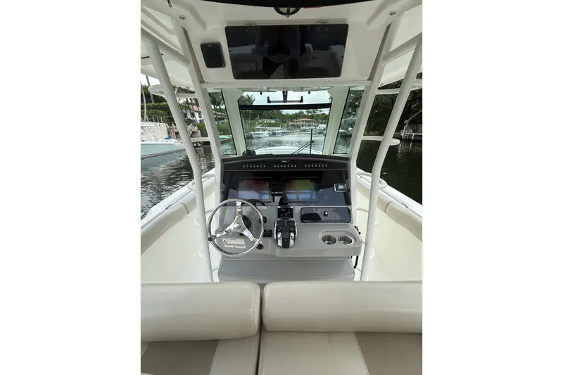 Slide: The Image of 2016 Boston Whaler 330 Outrage helm with modern navigation equipment and steering wheel. - 10