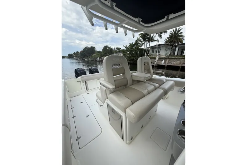 Slide: The Image of 2016 Boston Whaler 330 Outrage boat interior with seating, dockside view. - 17