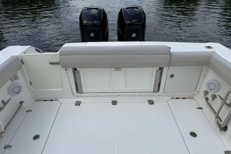 Slide: The Image of 2016 Boston Whaler 330 Outrage boat deck with twin engines and seating area. - 23